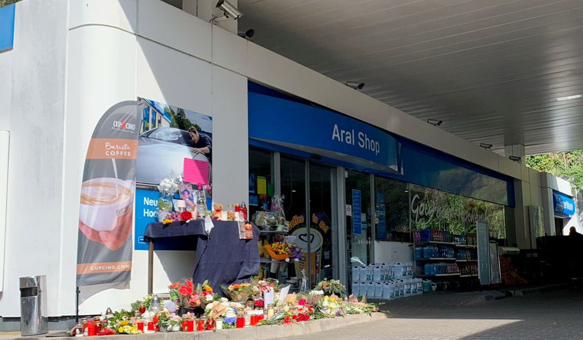 Flowers are placed in front of Germany gas station